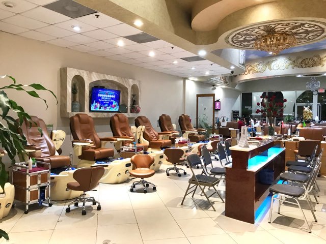 Pedicure chairs lined up inside a nail salon.